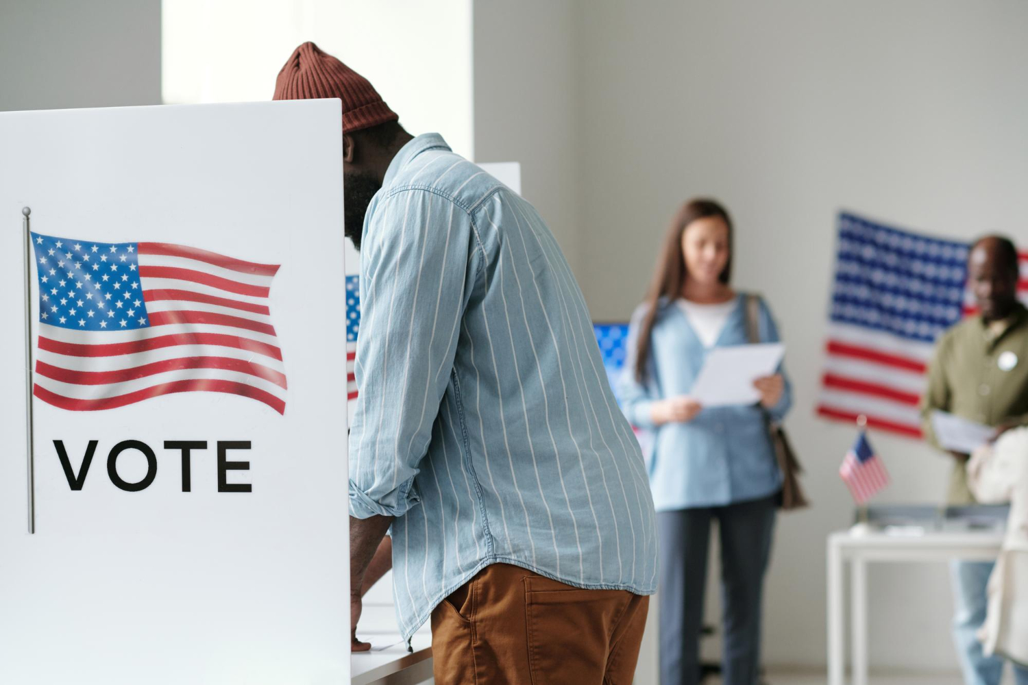 American people standing in voting booth