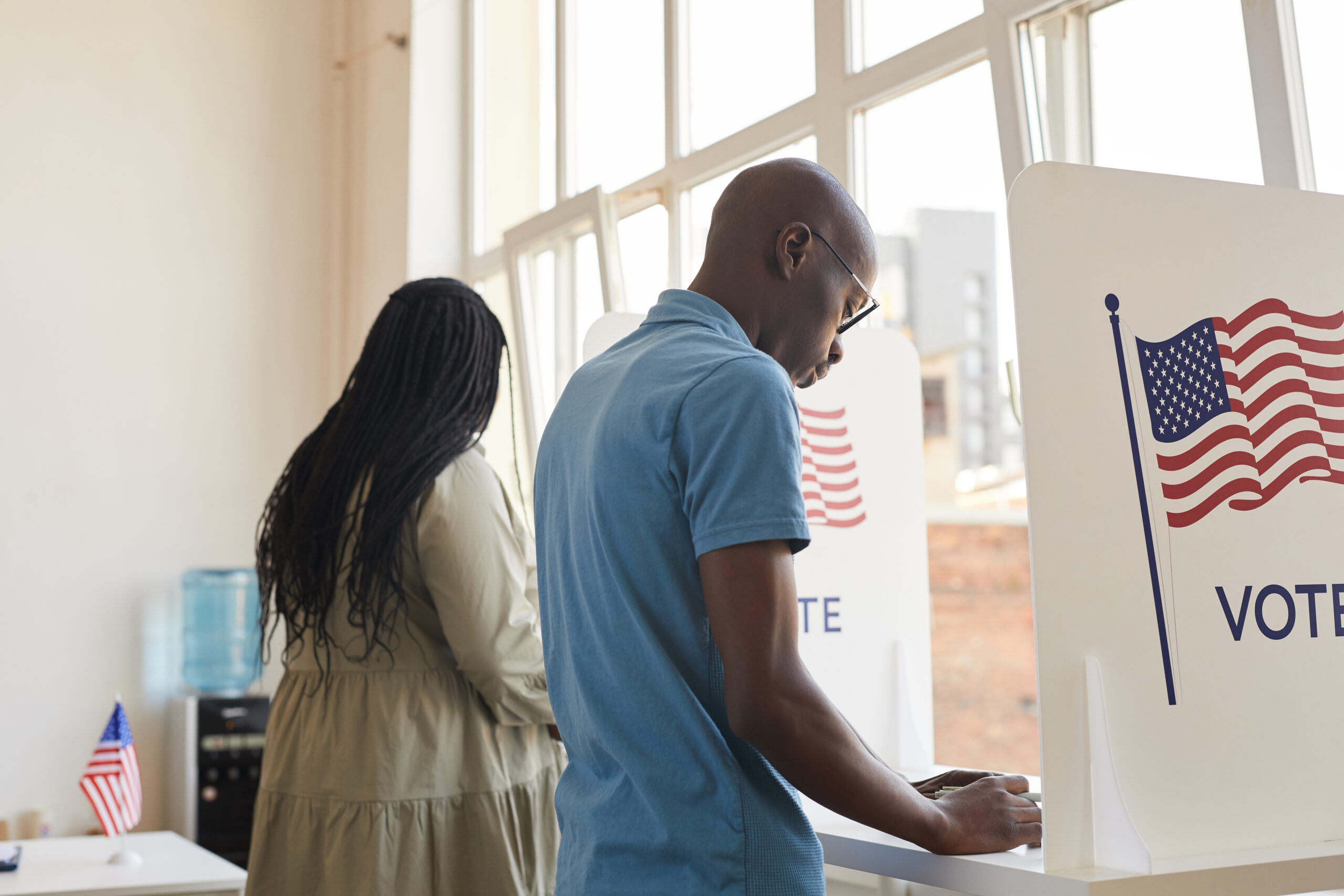American people standing in voting booth